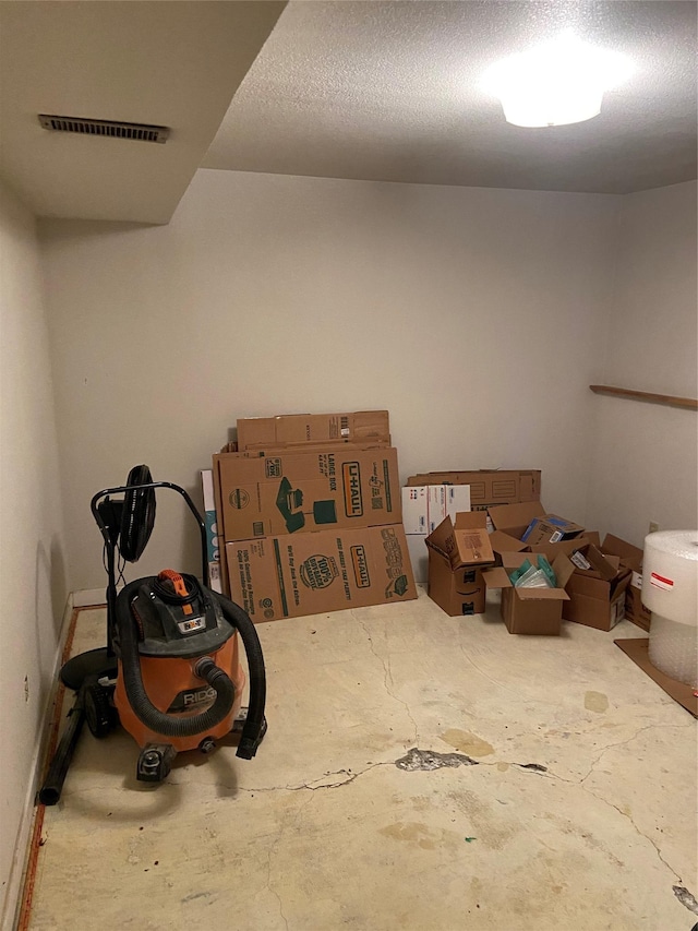 misc room featuring concrete flooring and a textured ceiling