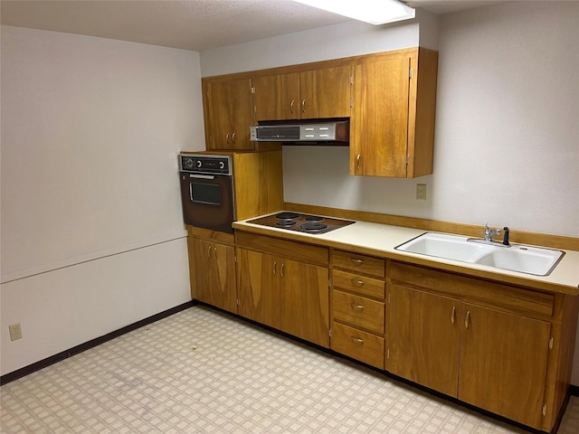 kitchen featuring electric stovetop, black oven, sink, and ventilation hood