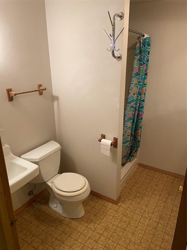 bathroom featuring shower / bath combination with curtain and toilet