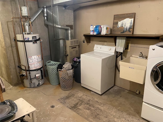 laundry room featuring separate washer and dryer, gas water heater, and sink