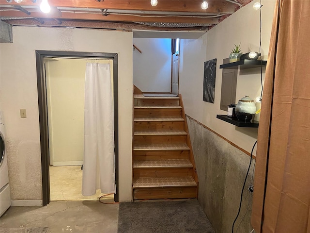 stairs with concrete flooring