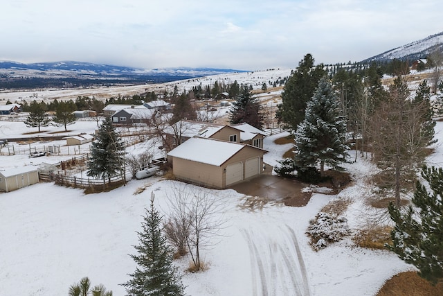 snowy aerial view with a mountain view