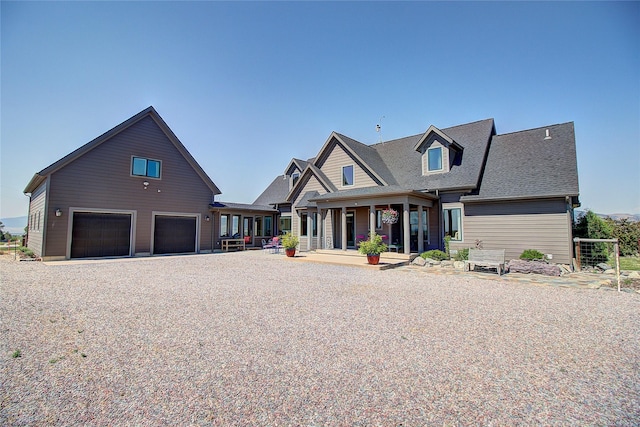 view of front of property featuring a porch and a garage