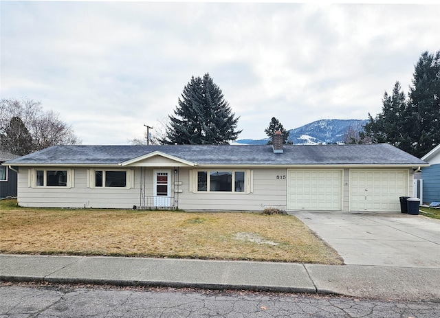 ranch-style house featuring a mountain view and a garage