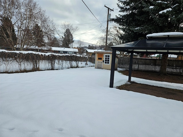 yard covered in snow featuring an outdoor structure