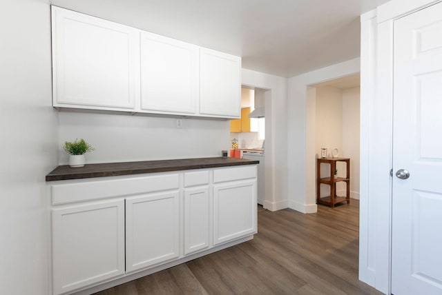 kitchen featuring white cabinetry and dark wood-type flooring