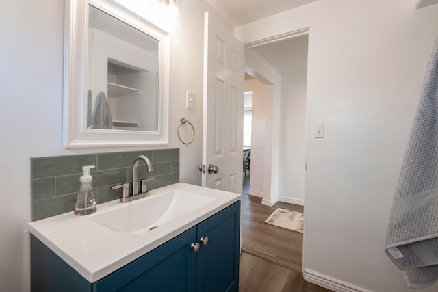 bathroom featuring tasteful backsplash, hardwood / wood-style floors, and vanity