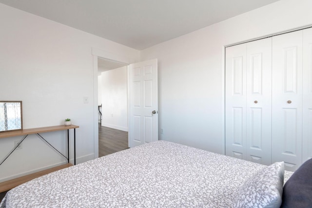 bedroom featuring dark hardwood / wood-style floors and a closet