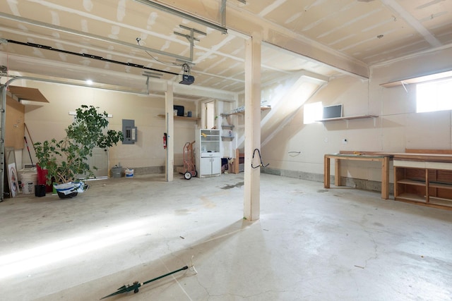 garage with electric panel and a garage door opener