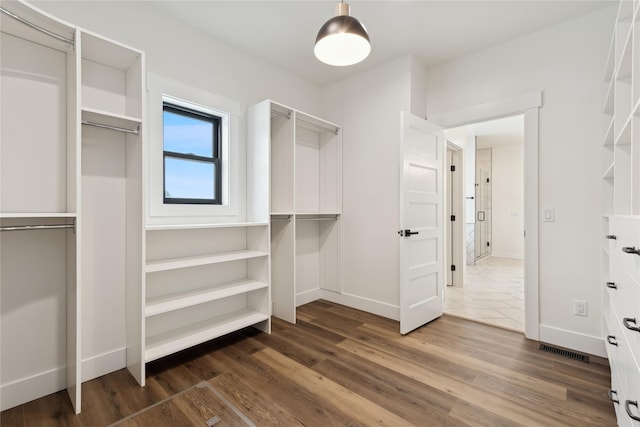 walk in closet featuring wood finished floors and visible vents