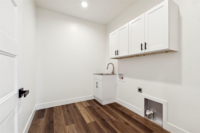 laundry area featuring cabinet space, baseboards, dark wood-style flooring, hookup for a washing machine, and electric dryer hookup