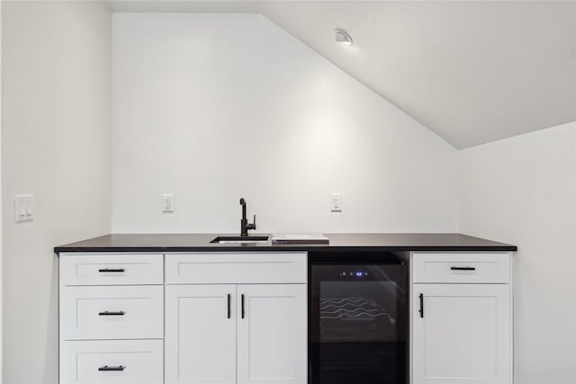 bar featuring lofted ceiling, wine cooler, indoor wet bar, and a sink