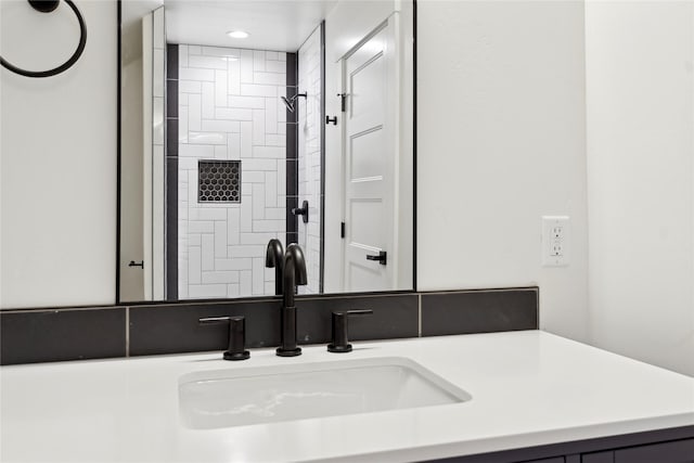 full bath with recessed lighting, tiled shower, and vanity