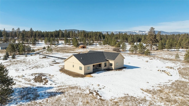 snowy aerial view featuring a mountain view