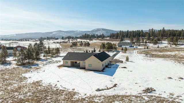 snowy aerial view featuring a mountain view