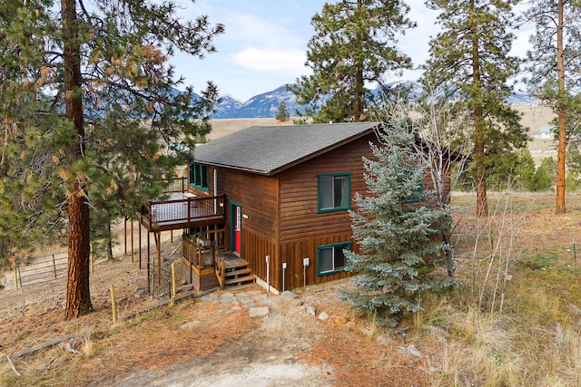 view of side of home featuring a deck with mountain view