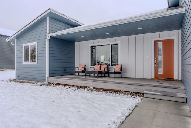 snow covered property featuring covered porch