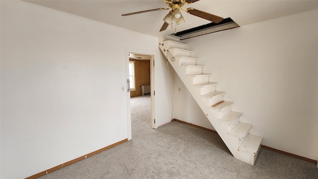 interior space with baseboards, carpet floors, and ceiling fan