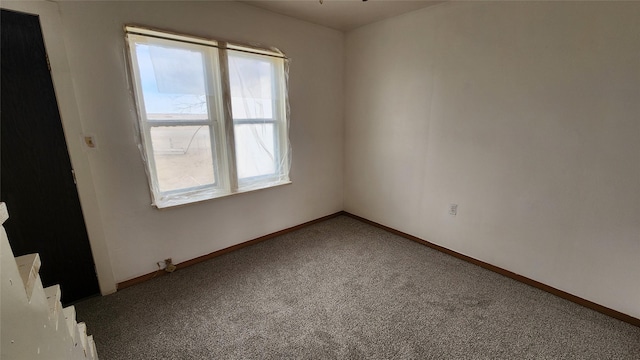 carpeted empty room with baseboards