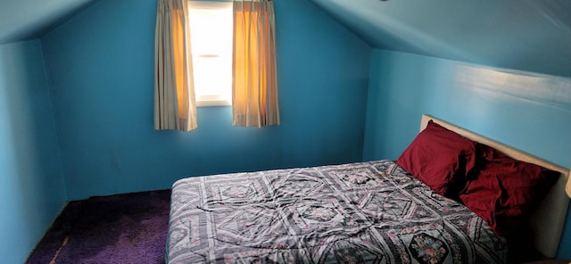 carpeted bedroom featuring lofted ceiling