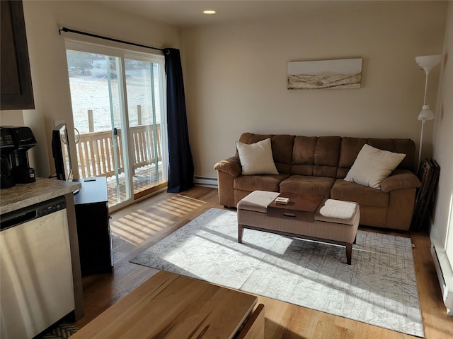 living room with hardwood / wood-style flooring and a baseboard heating unit