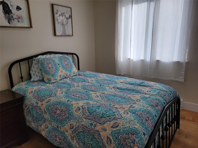 bedroom with hardwood / wood-style floors