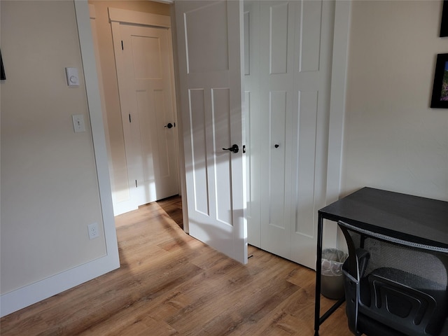 hallway with light hardwood / wood-style floors