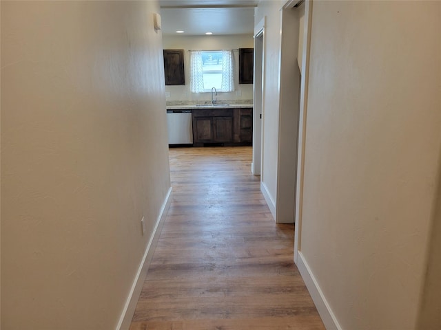 hall featuring sink and light hardwood / wood-style flooring