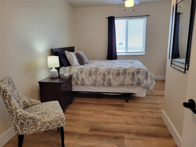 bedroom with light hardwood / wood-style floors and ceiling fan