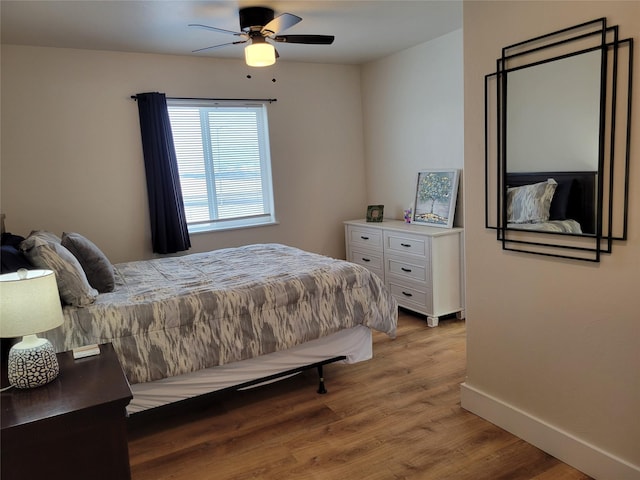 bedroom with ceiling fan and light hardwood / wood-style flooring