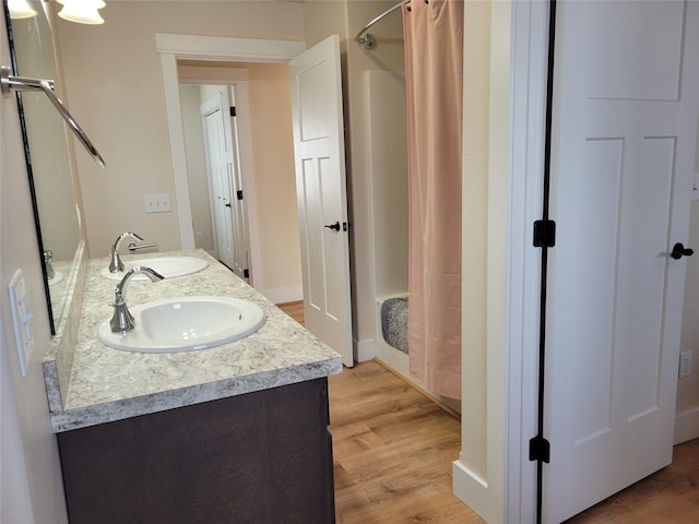 bathroom with vanity, wood-type flooring, and walk in shower