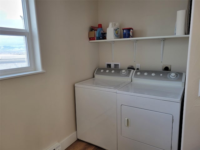 clothes washing area featuring independent washer and dryer, plenty of natural light, and hardwood / wood-style floors