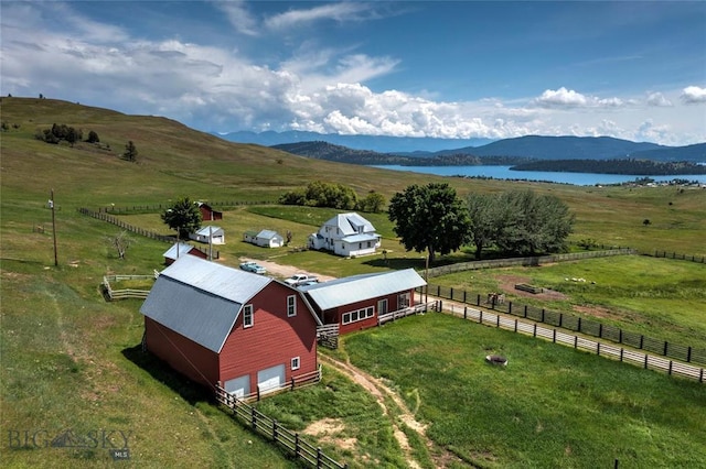 aerial view featuring a water and mountain view and a rural view