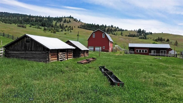 view of yard with an outbuilding and a rural view