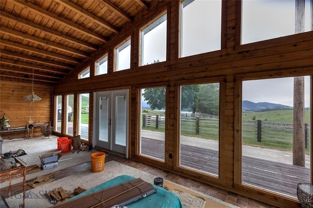 interior space featuring beam ceiling, a rural view, high vaulted ceiling, and wood ceiling