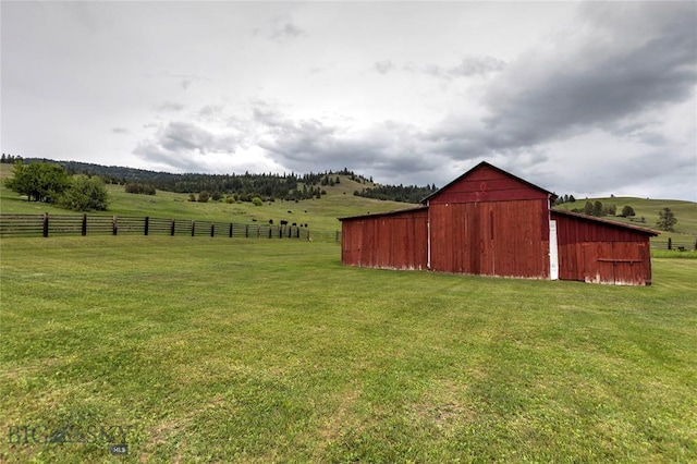 view of yard featuring a rural view and an outdoor structure