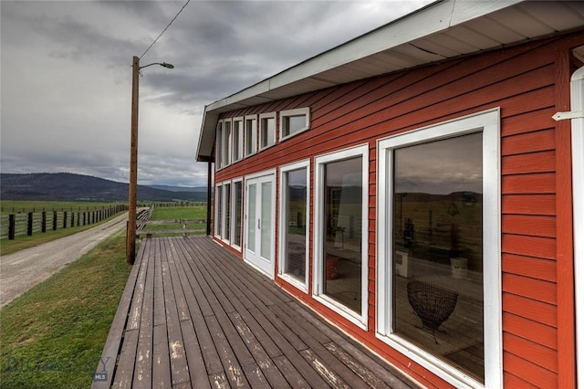 wooden deck featuring a mountain view and a rural view