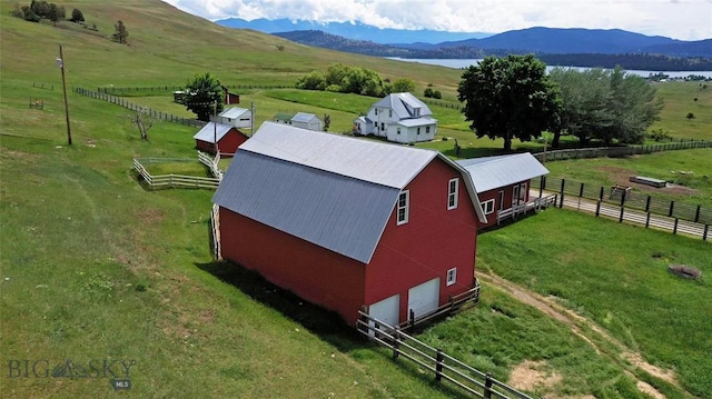 birds eye view of property with a mountain view and a rural view