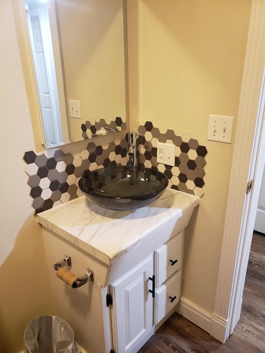 bathroom featuring hardwood / wood-style floors, vanity, and tasteful backsplash