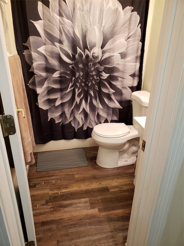 bathroom featuring wood-type flooring and toilet