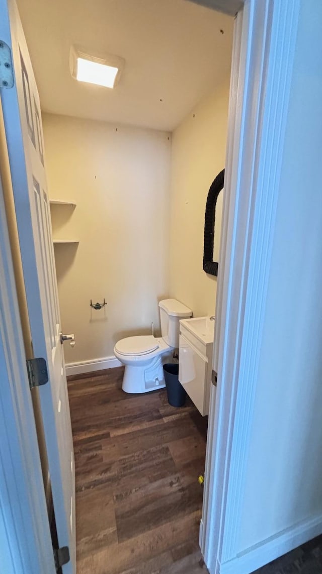 bathroom featuring hardwood / wood-style floors, vanity, and toilet