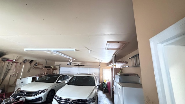 garage with washer / dryer and a garage door opener