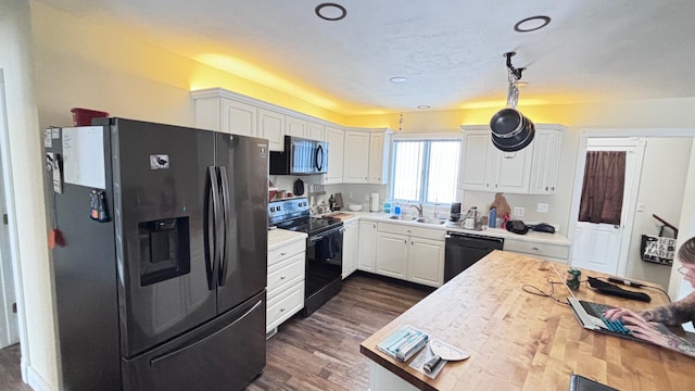 kitchen with dark hardwood / wood-style flooring, sink, white cabinetry, and black appliances