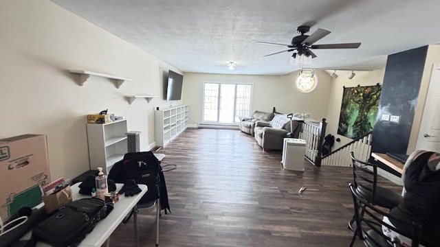 living room featuring a textured ceiling, ceiling fan, and dark wood-type flooring