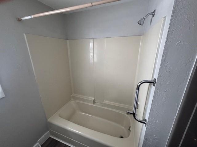 bathroom featuring hardwood / wood-style floors and shower / tub combination