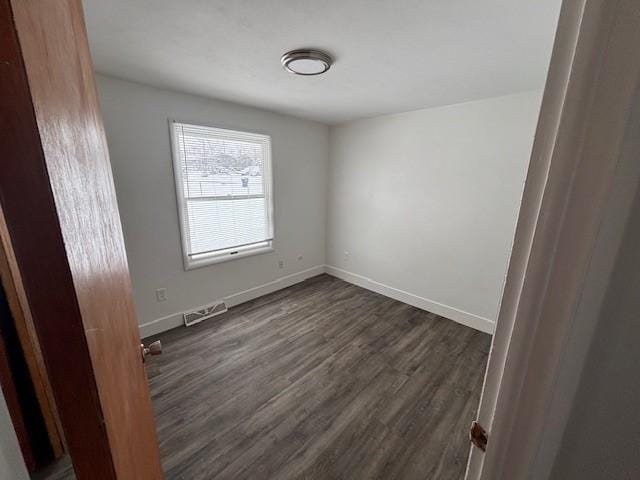 empty room featuring dark hardwood / wood-style floors