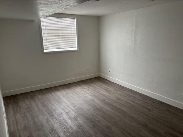 empty room with dark wood-type flooring