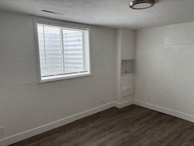 empty room featuring dark hardwood / wood-style flooring