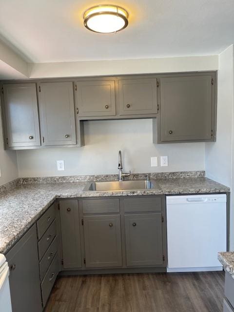 kitchen featuring white dishwasher, dark hardwood / wood-style flooring, gray cabinetry, and sink