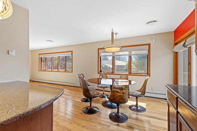 dining room featuring light hardwood / wood-style flooring and baseboard heating